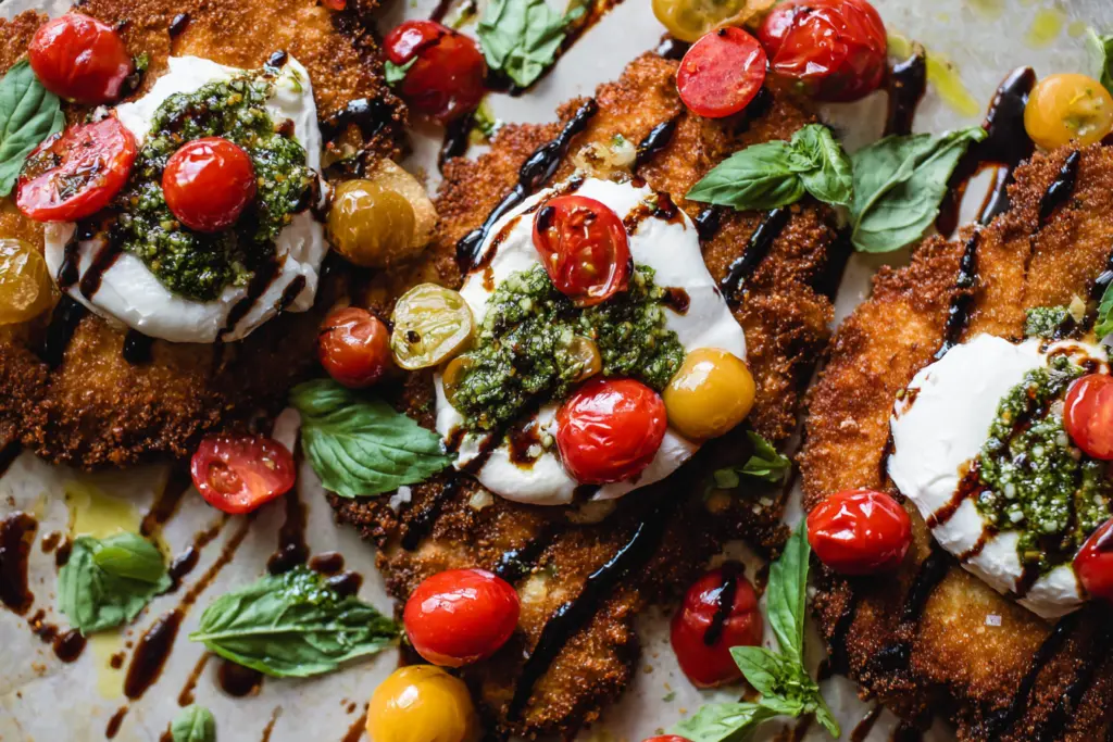 Crispy Italian Basil Chicken Cutlets with burrata, cherry tomatoes, and balsamic glaze