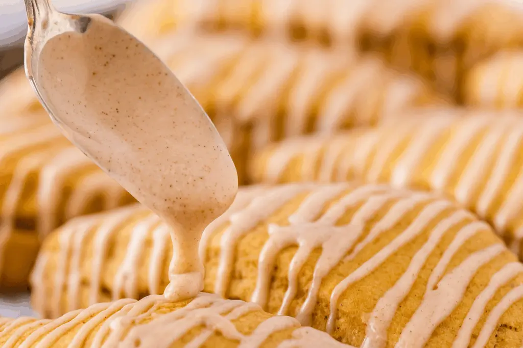 Pumpkin Scones with Cinnamon Maple Glaze 5 Drizzling Cinnamon Maple Glaze on Pumpkin Scones