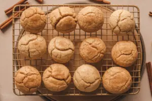 A batch of golden-baked churro cheesecake cookies stacked fresh