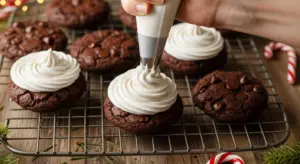 Pipe fluffy marshmallow frosting onto cooled hot cocoa cookies.