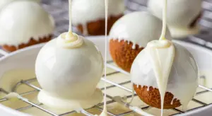 Dip each chilled Biscoff truffle balls into the melted white chocolate