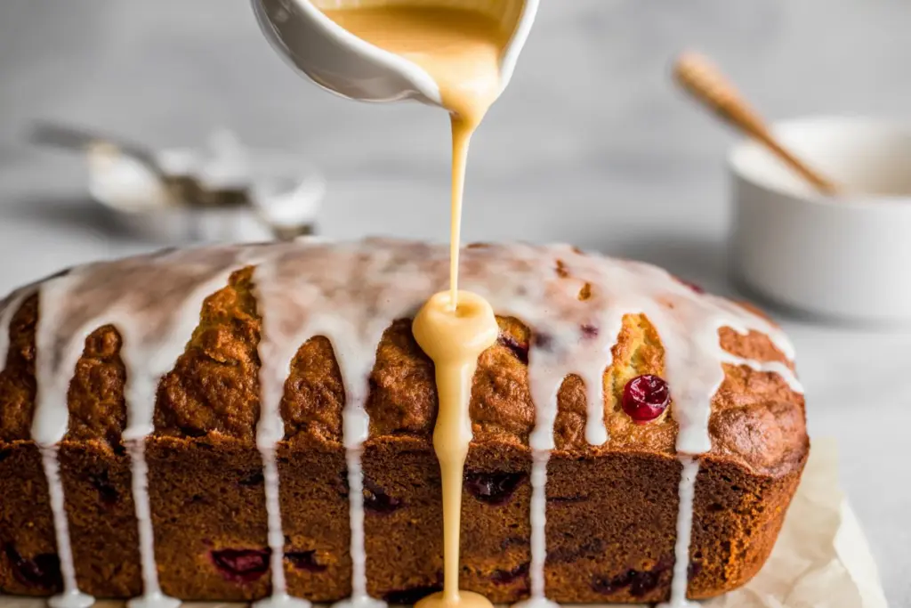 pouring-orange-glaze-cranberry-bread