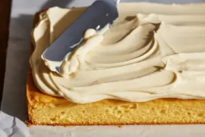 Easy Sourdough Vanilla Sheet Cake 15 Spread frosting evenly over the cooled cake.