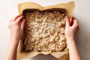 Strawberry Oatmeal Crumble Bars 7 Pressing oat crust for strawberry oatmeal crumble bars