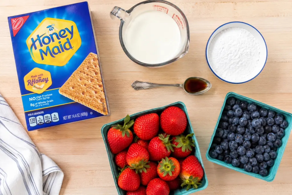 No-Bake Berry Icebox Cake ingredients on wooden surface