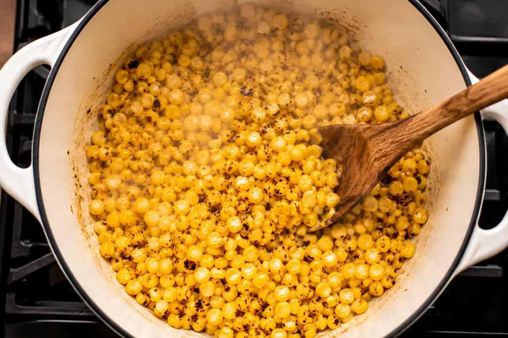 Easy Mexican Street Corn Soup 3 Corn sautéing in a Dutch oven